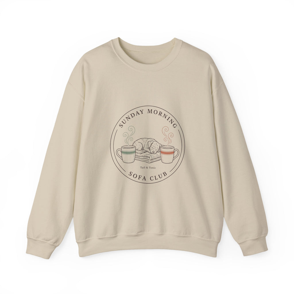 Sand Sunday Morning Sofa Club crewneck with a round badge of a dog asleep between two coffee mugs, front view