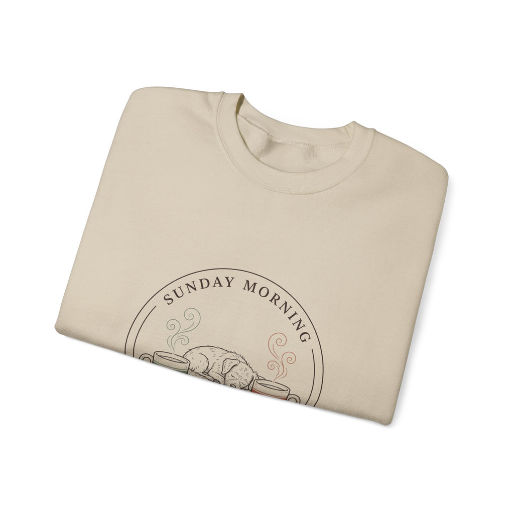 Close-up of the Sunday Morning Sofa Club badge on a folded sand crewneck