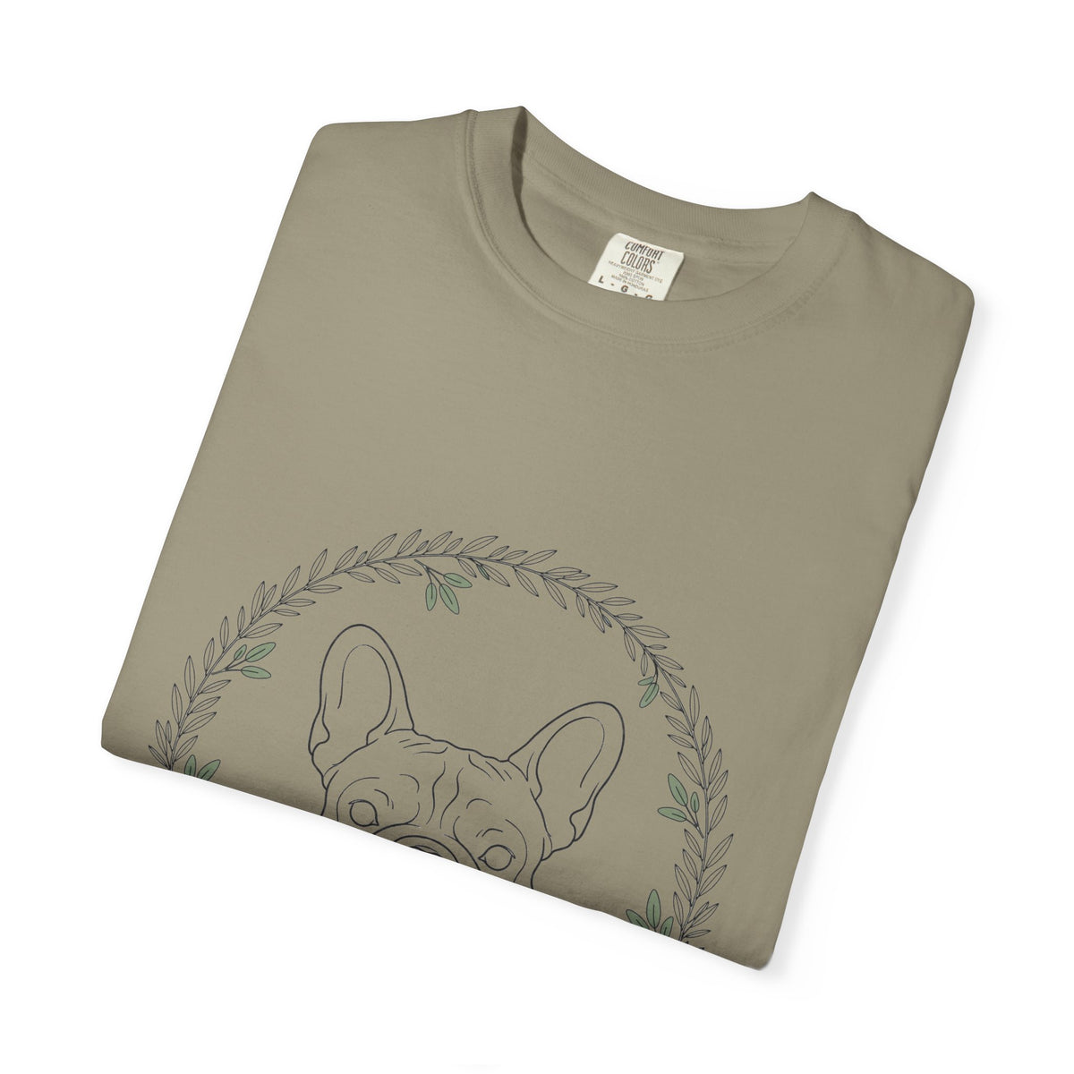 Close-up of the French bulldog and leaf wreath print on a folded sandstone tee
